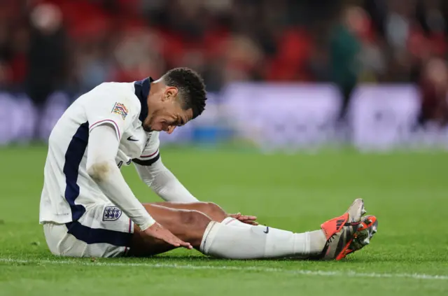 Jude Bellingham sitting on the pitch