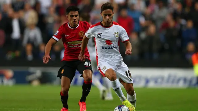 George Baldock playing for MK Dons against Manchester United