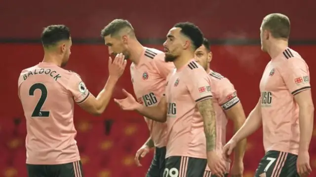 George Baldock congratulates Sheffield United team-mate Kean Bryan