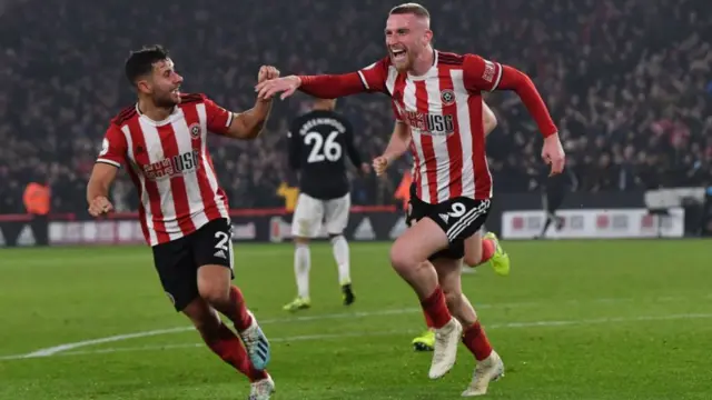 George Baldock celebrates a Sheffield United goal with Oli McBurnie