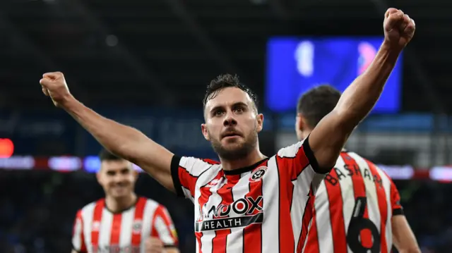 George Baldock celebrates while playing for Sheffield United