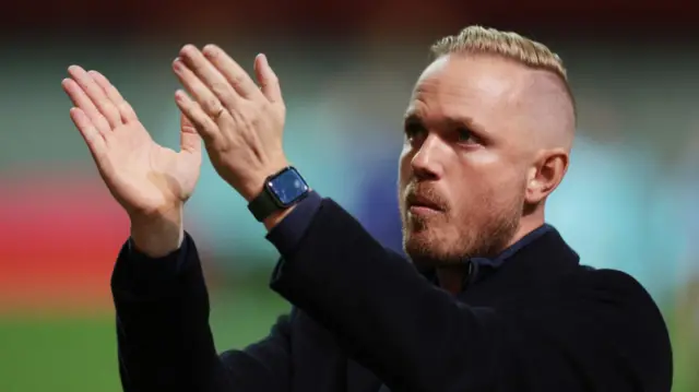 Coach Jonas Eidevall applauds the Arsenal fans after their defeat Bayern Munich
