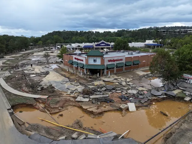 Retail outlets surrounded by water and debris