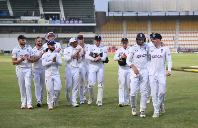 England's players walk off the field at the end of day four in Multan
