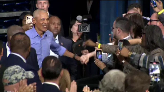 Obama shakes hands and smiles