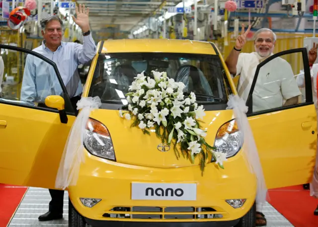 Ratan Tata, chairman of the Tata Group, and Gujarat's chief minister Narendra Modi, gesture as they stand beside the Tata Nano car during the inauguration ceremony of a new plant for the Tata Nano, at Sanand, in the western Indian state of Gujarat, India June 2, 2010.