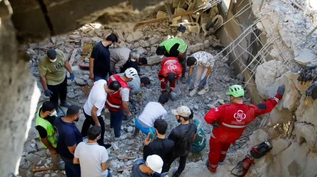 Rescue workers search though a building in Wardaniyeh, South Lebanon