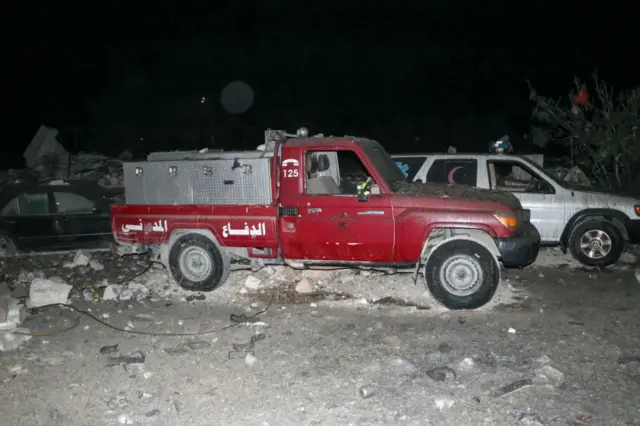 Debris covers wrecked Civil Defence vehicles following an overnight Israeli airstrike