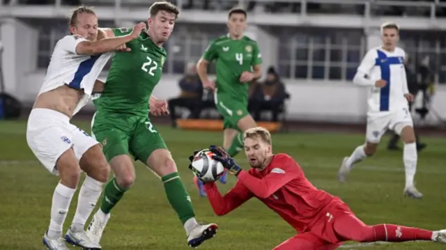 Republic of Ireland keeper Caoimhin Kelleher gets down to make the save against Finland