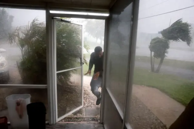 A man runs for cover in Fort Myers