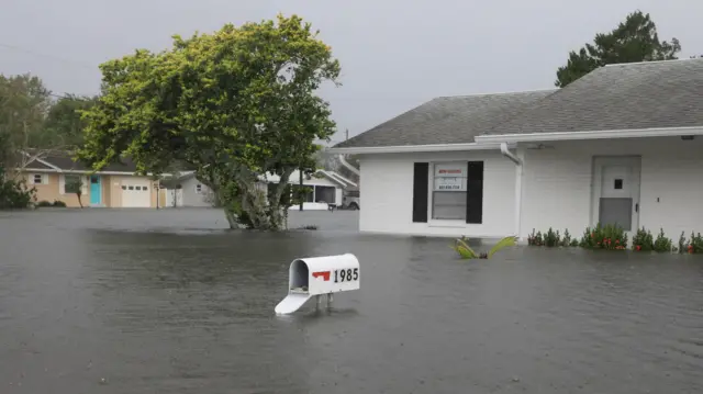 A mailbox whose door was forced open remains above flooding after Hurricane Milton passed in South Daytona.