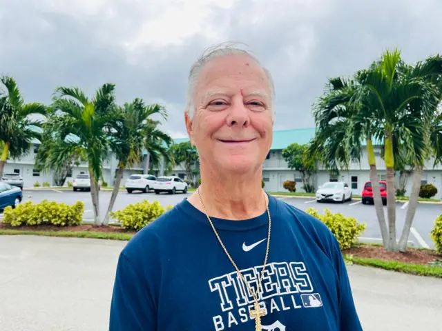 Kip Lanway stands in front of apartment building