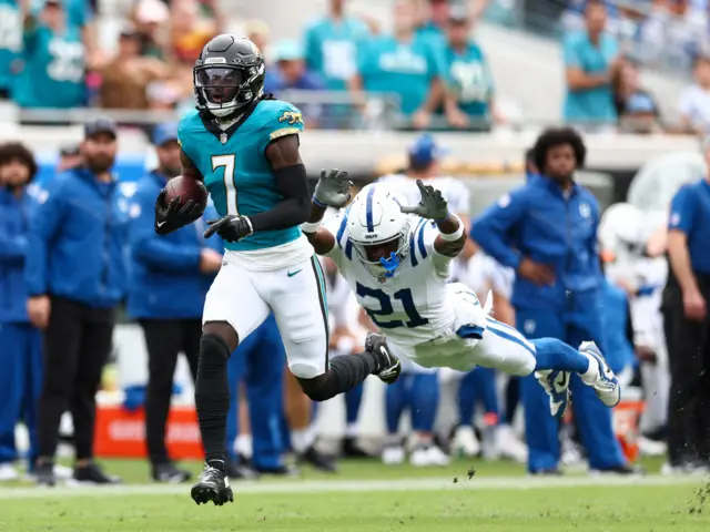 Jacksonville Jaguars wide receiver Brian Thomas Jr outruns a diving tackle from Indianapolis Colts cornerback Dallis Flowers