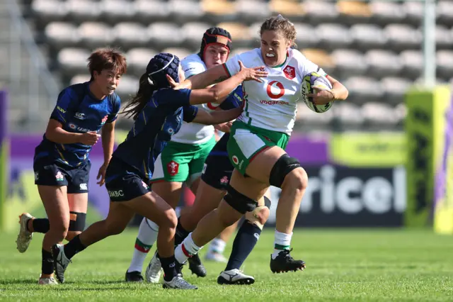 Natalia John of Wales attempts to break the tackle