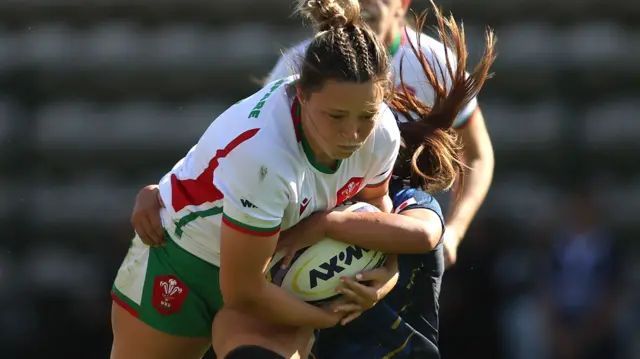 Alisha Butchers of Wales attempts to break the tackle