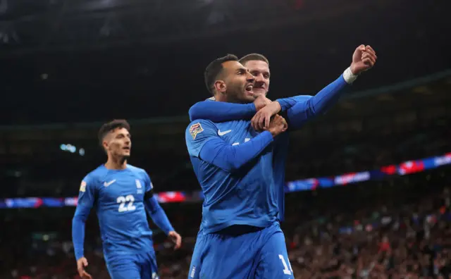 Vangelis Pavlidis celebrates with Greece teammates after scoring against England