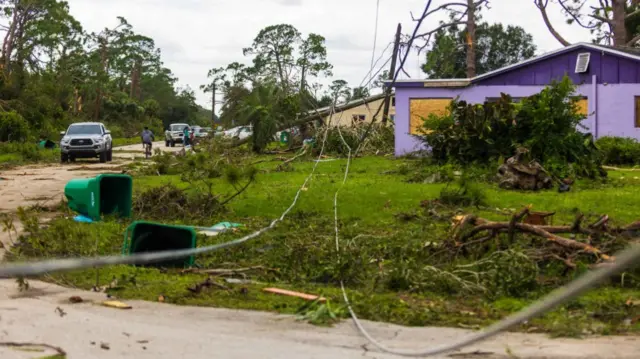 Road ways left damaged and downed power lines by a tornado caused by Hurricane Milton