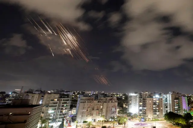 Streaks of rocket fire fired against a nightsky over Ashkelon in Israel as Israel's missile defense system intercepts Iranian ballistic missiles