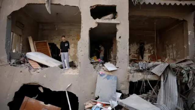 A man stands in the damaged apartment of Ahmed Al-Khatib at the strike site in Beirut, Lebanon, October 11, 2024