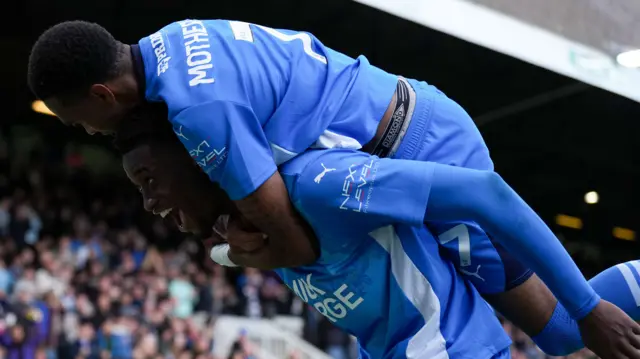 Malik Mothersille jumps on Emmanuel Fernandez's back after his equaliser for Peterborough against Rotherham