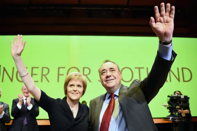 First Minister of Scotland Alex Salmond, acknowledges applause with Nicola Sturgeon following his last key note speech as party leader of the SNP at the partys annual conference on November 14, 2014 in Perth, Scotland