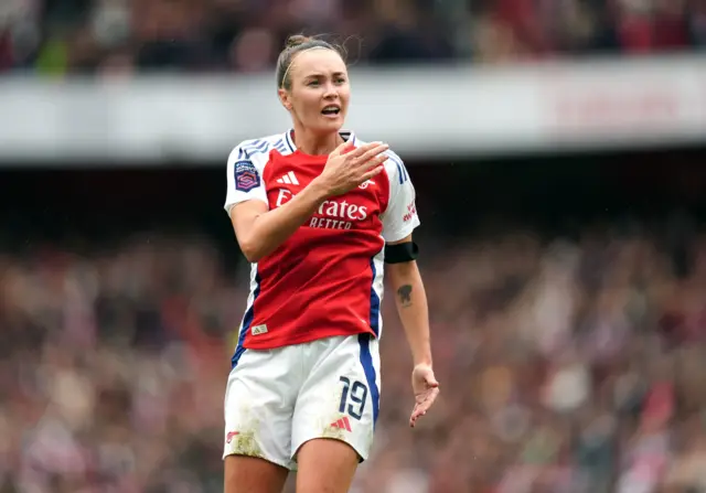 Foord slaps the Arsenal badge on her chest to celebrate her goal