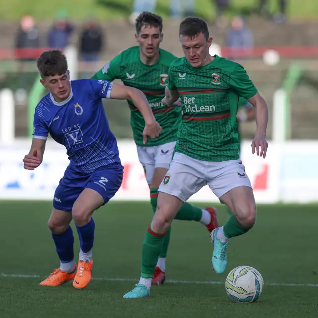Glentoran's Danny Amos attempts to burst away from Dungannon's Stephen Scott