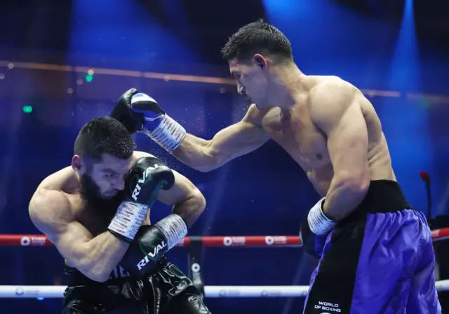 Artur Beterbiev ducking under Dmitry Bivol punch