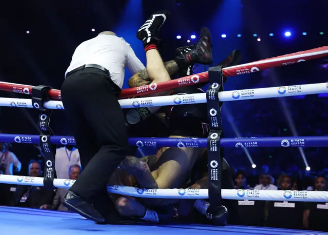 Referee tries to grab Ben Whittaker and Liam Cameron behind the ropes