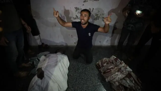 A man shouts as bodies of Palestinians, who lost their life after Israeli attack on Jabalia refugee camp, are brought to al-Ahli Baptist Hospital for burial