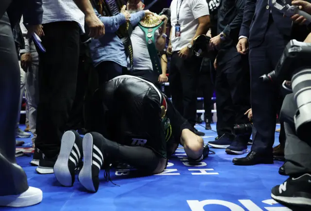 Artur Beterbiev prays after winning a fight