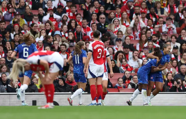 Arsenal players stand stunned as Chelsea celebrate