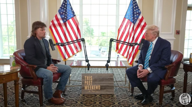 Donald Trump and Theo Von on a set in front of microphones and two American flags