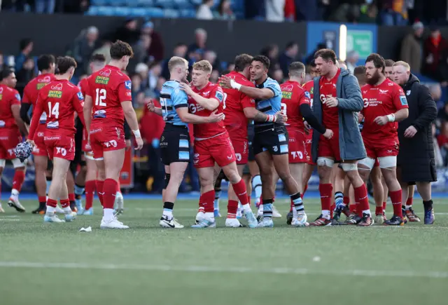 Players from both sides shake hands at full time