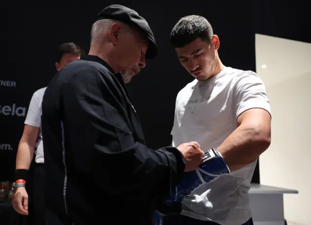 Dmitry Bivol puts blue gloves on