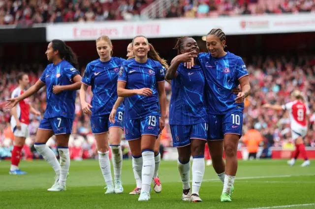 Baltimore is mobbed by teammates after her goal