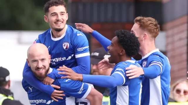 Chesterfield players celebrate with Paddy Madden