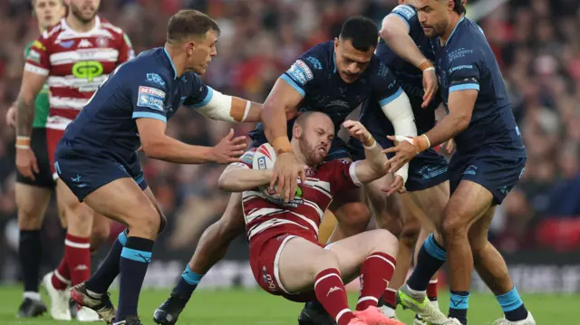 Liam Marshall tackled by Hull KR players