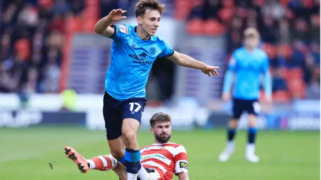 Matus Holicek of Crewe Alexandra dribbles past Doncaster's Brandon Fleming