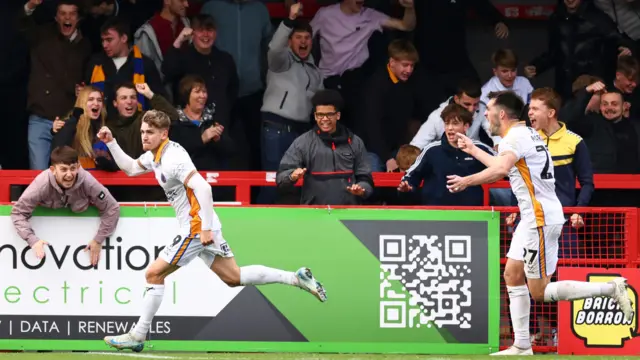 George Lloyd celebrates in front of the Shrewsbury fans