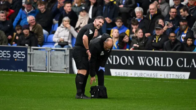 Referee Neil Hair receives treatment