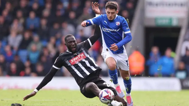 Armando Dobra goes on the attack for Chesterfield, tracked by Notts County goalscorer Alassana Jatta