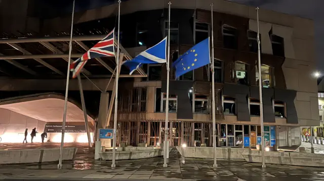 Union Jack, Saltire and EU flag at half mast outside Holyrood