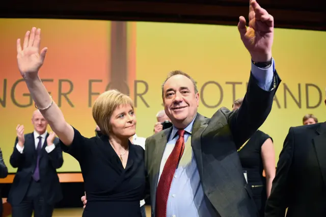 First Minister of Scotland Alex Salmond, acknowledges applause with Nicola Sturgeon following his last key note speech as party leader of the SNP at the partys annual conference on November 14, 2014 in Perth, Scotland