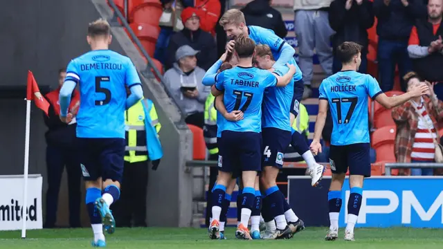 Max Conway is mobbed by his Crewe teammates