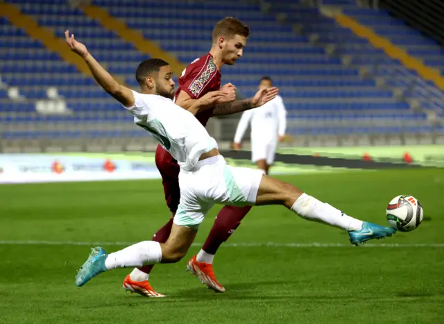 Brodie Spencer challenges for the ball