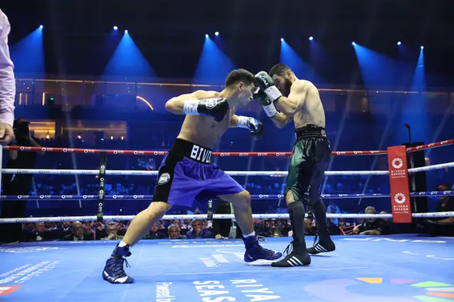 Dmitry Bivol throwing a punch at Artur Beterbiev