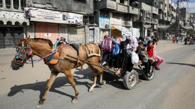 Women and children on a donkey cart.