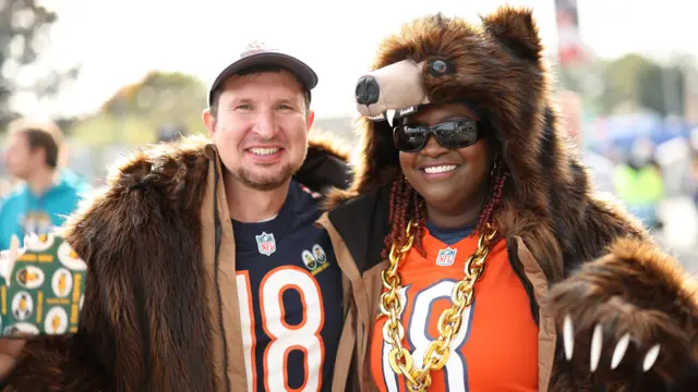 Chicago Bears fans in fancy dress pose for a photograph