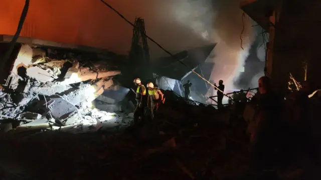 Rescue workers attend site of strikes in Nabatieh in southern Lebanon